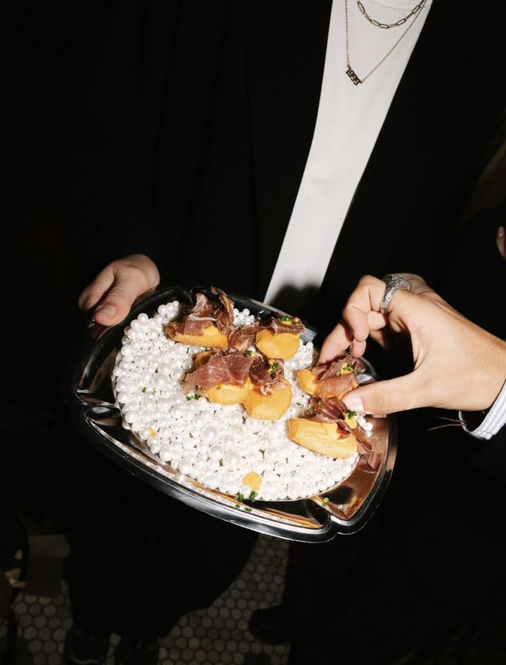 Melon and cured ham served on a silver platter