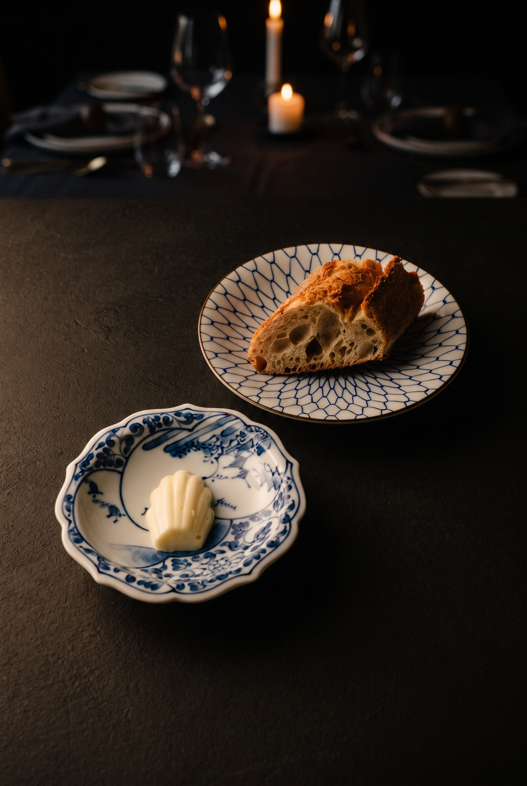 Sourdough and shell-shaped butter on porcelain