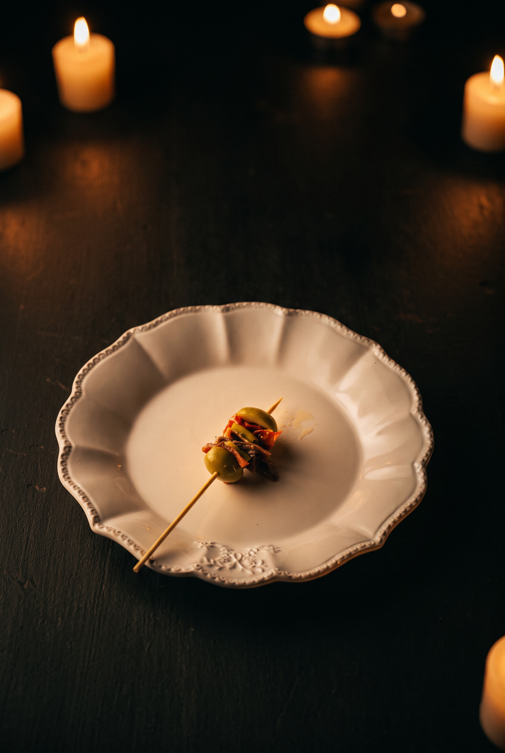 An olive and anchovy skewer